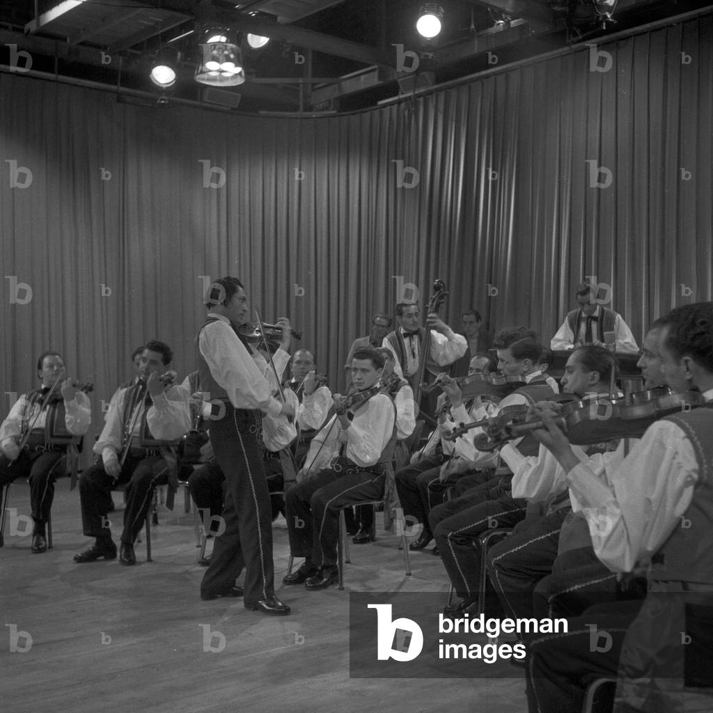 Musicians playing their violins in a gipsy orchestra at the studio, Germany 1950s