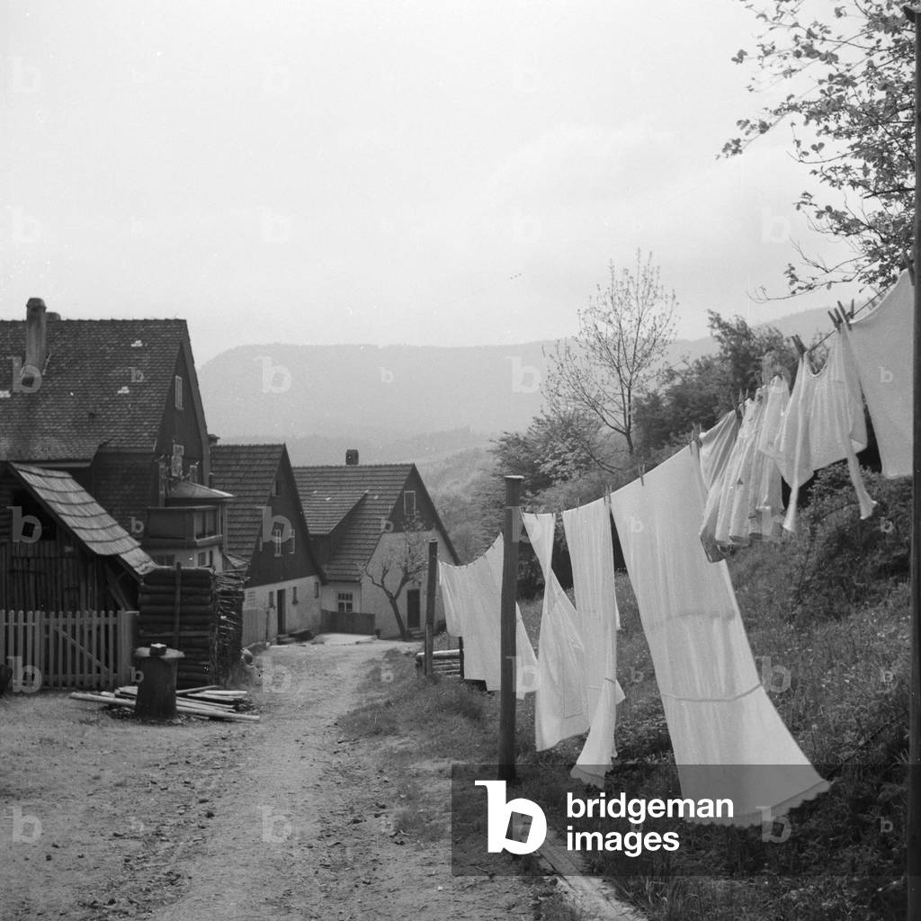 Freshly washing for drying at a village in Black Forest region, Germany 1930s (b/w photo)