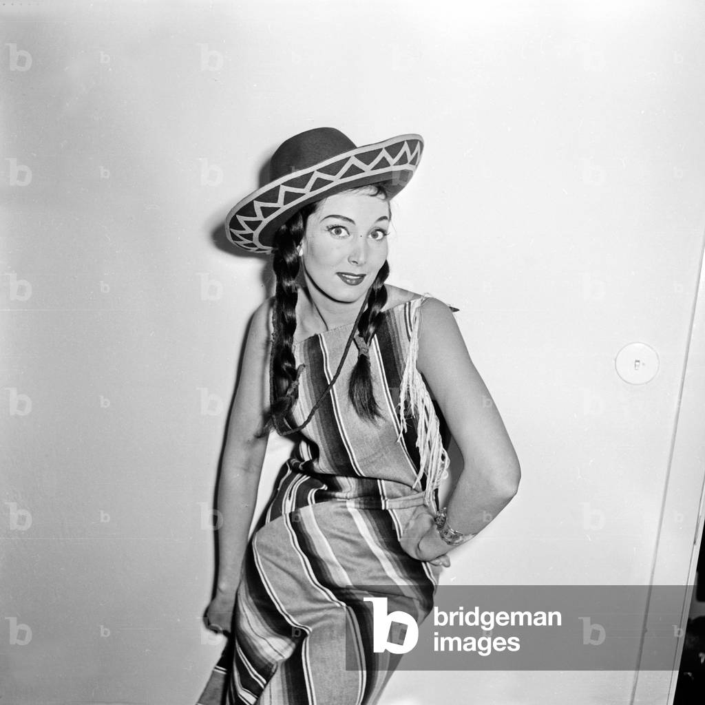 doing a promotional photo shoot wearing a poncho and a sombrero hat, Germany 1950s