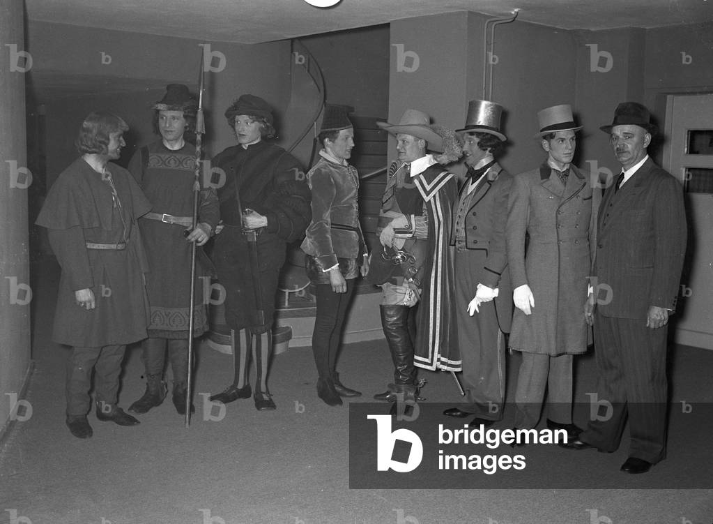 A music crew around a musician at the broadcasting building in Berlin, Germany 1930s (b/w photo)