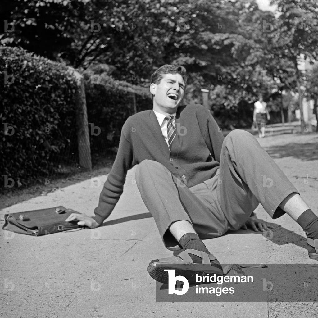 A man slipped because a banana peel on the street, Germany 1960s