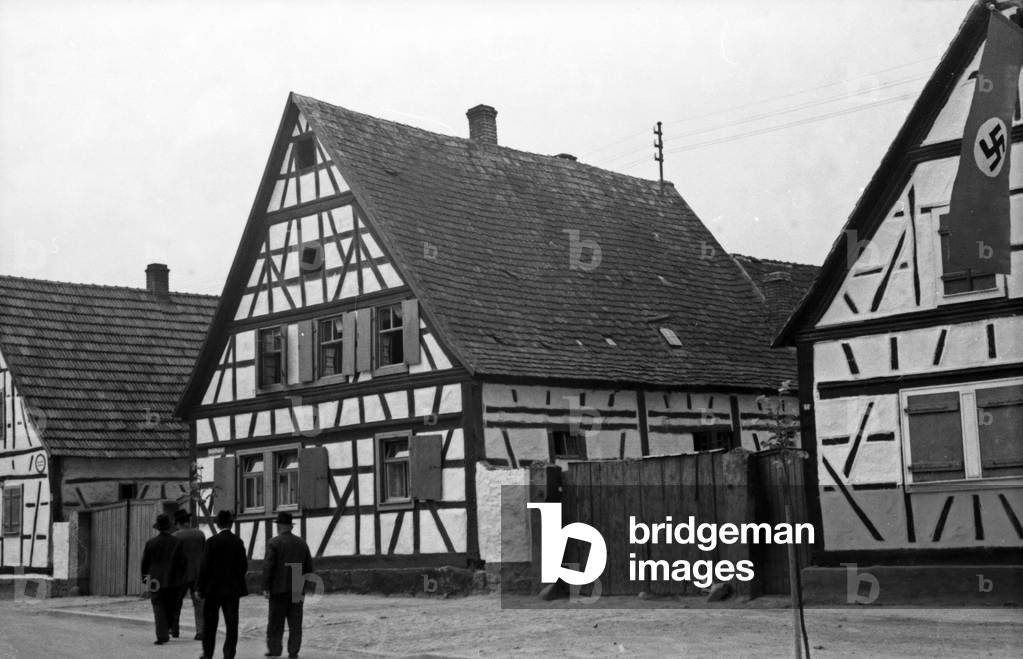 Four men walking to the main square of the annual radish fair at Schifferstadt, Germany 1930s (b/w photo)
