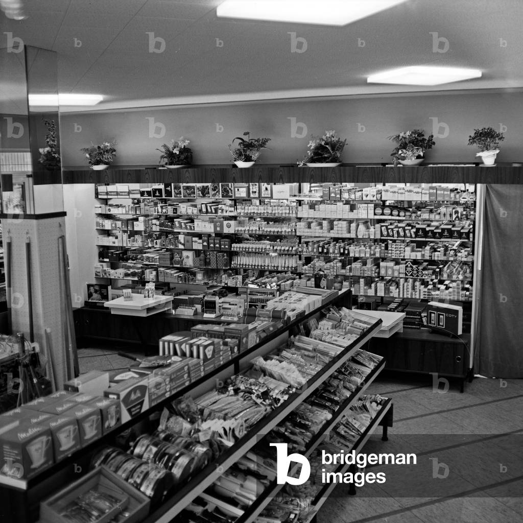 Filled shelving at a chemist's shop in Hamburg, Germany 1960s