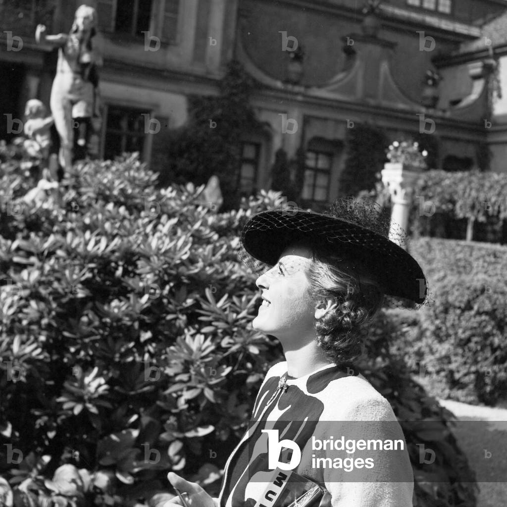 A woman standing at a public garden, Germany 1930s (b/w photo)