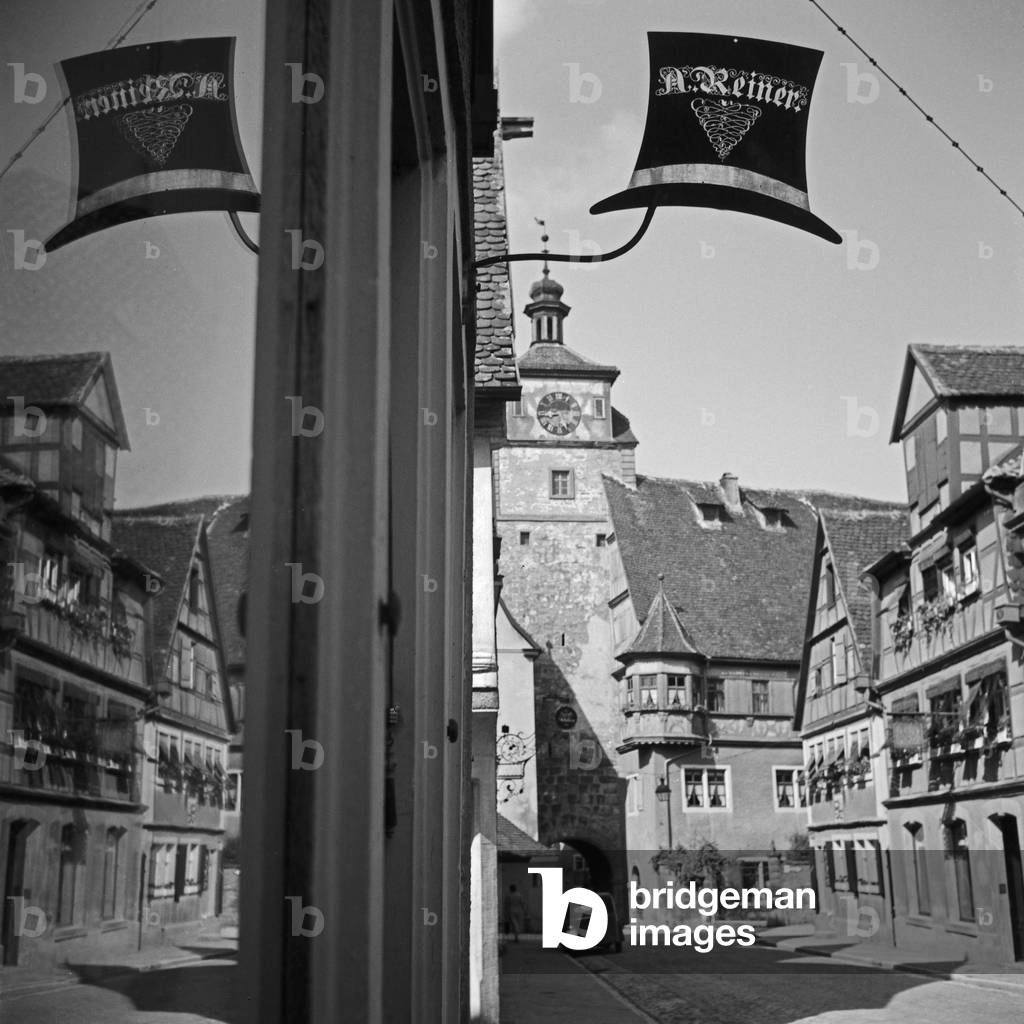 White tower with Reiner's hat shop in front of at Rothenburg ob der Tauber, German 1930s (b/w photo)