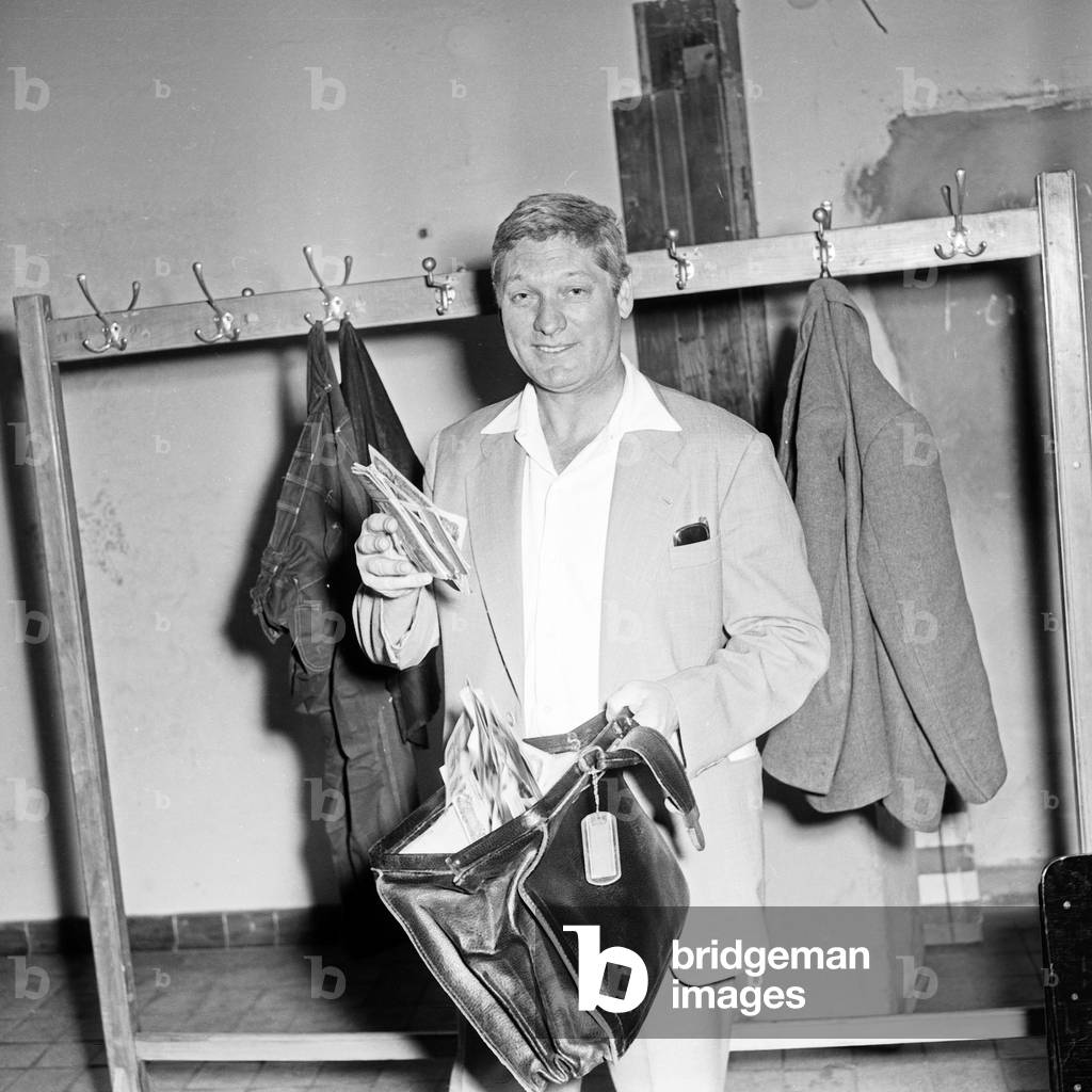 People in their job at NDR TV channel: a property master with a bag of banknotes, Germany 1950s