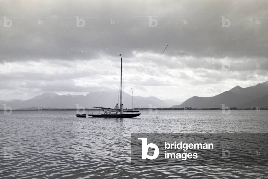A group of sailors is hoisting the sails on the Chiemsee, Germany 1930s (b/w photo)