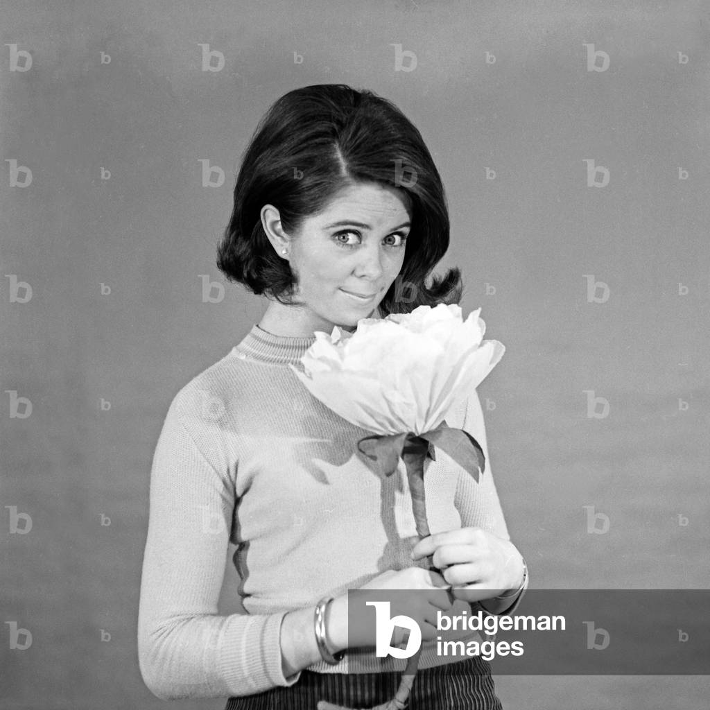 Norwegian schlager singer Wencke Myhre with a flower of paper, 1960s
