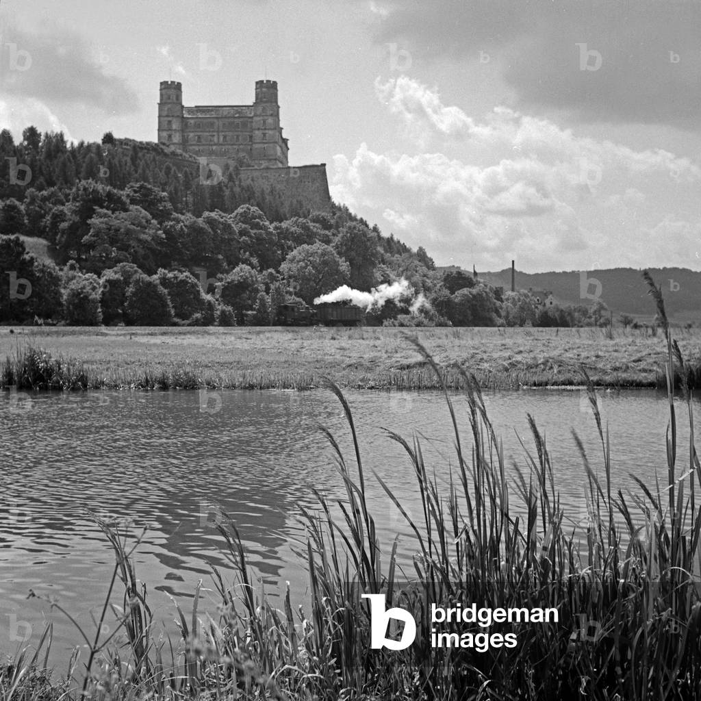View to Willibaldsburg castle at Eichstaett with the steam of a steam locomotive, Germany 1930s (b/w photo)