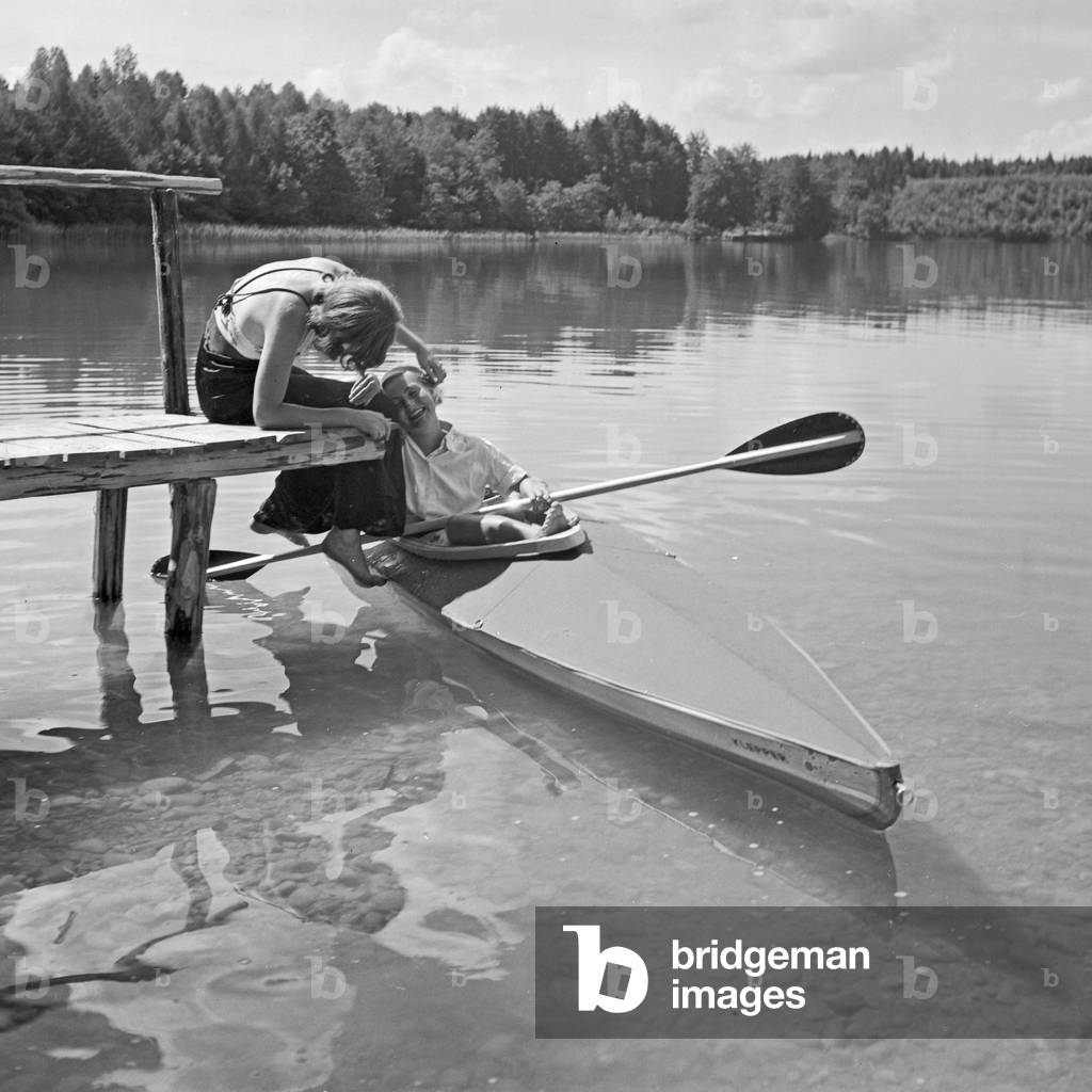 Two young women at a boardwalk on the shore of a lake in the Wachau area, Germany 1930s (b/w photo)