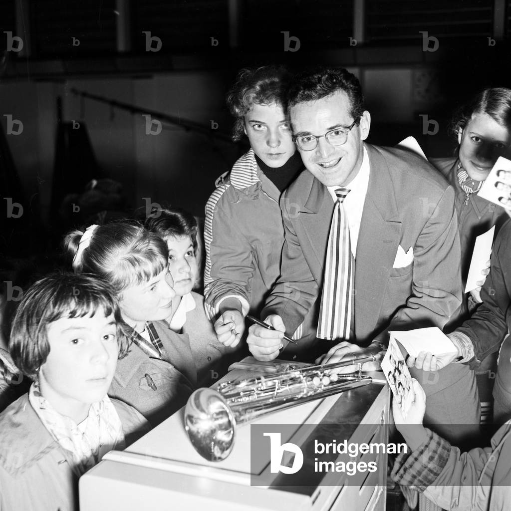 Swiss band leader and singer Hazy Osterwald signing autographs at Hamburg, Germany 1950s