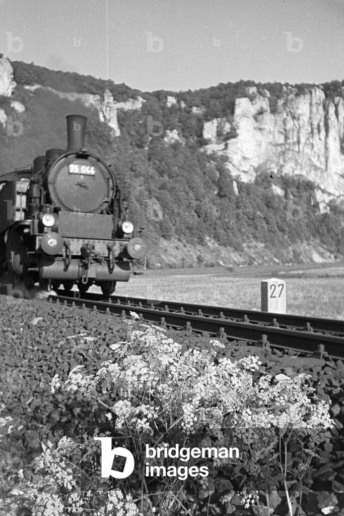 Idyllic panoramic view of the Black Forest with a train driving through the valley, Germany 1930s (b/w photo)