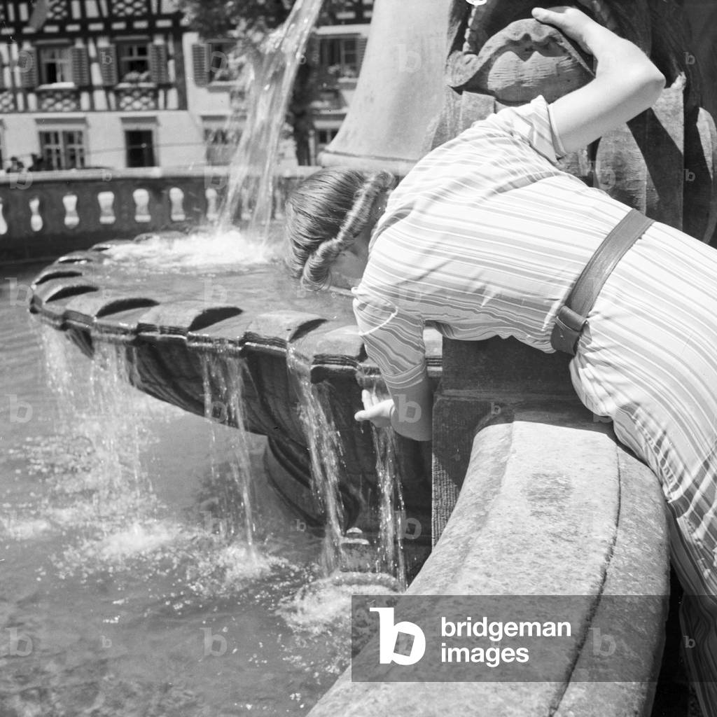 Woman by a fountain, Germany 1930s (b/w photo)