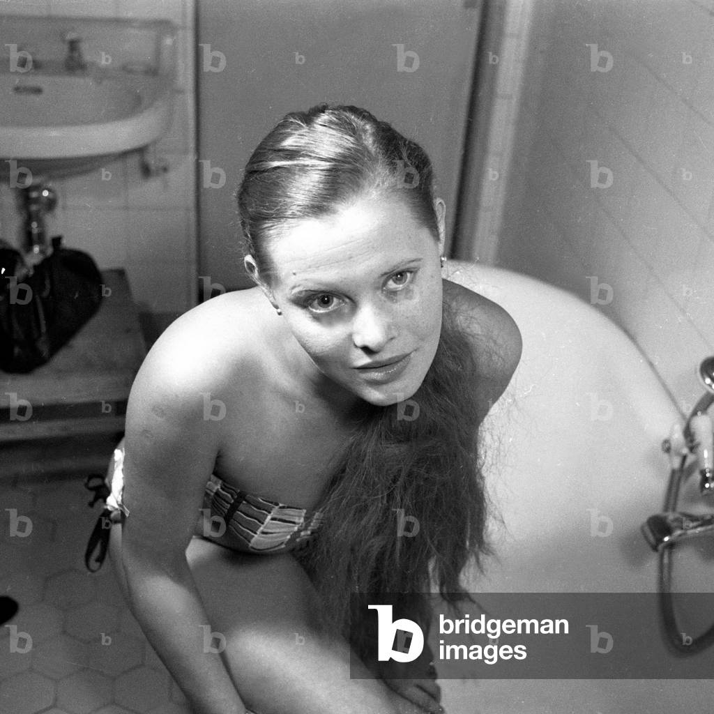 Saturday means bathing day! A young woman in a bathroom, Germany 1950s