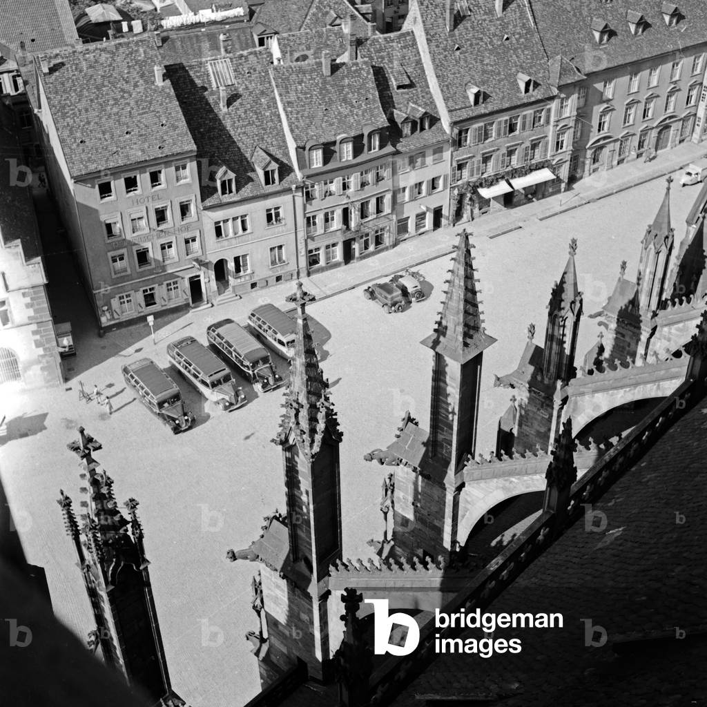 View from the belfry of the minster at Freiburg to the roofs of the city and coaches, Germany 1930s (b/w photo)