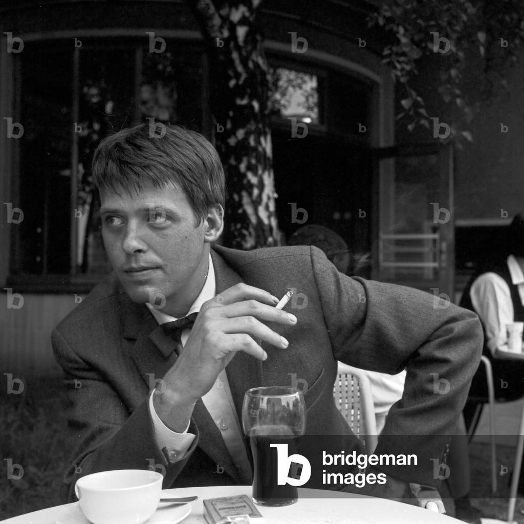 German actor Michael Berger sitting in a street cafe, Germany 1960s