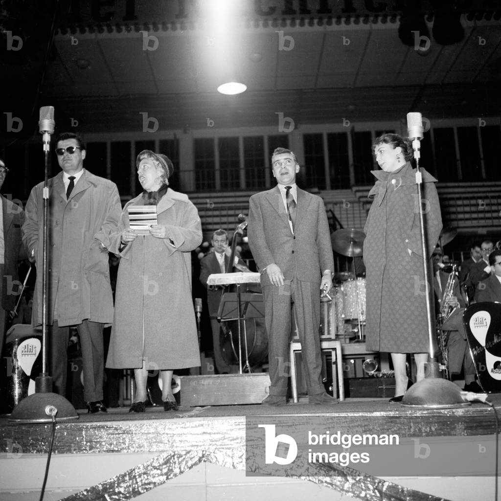 The stars of a concert, hosted by Kieler Nachrichten newspaper and Polydor record label, in their coats on stage, Kiel 1954