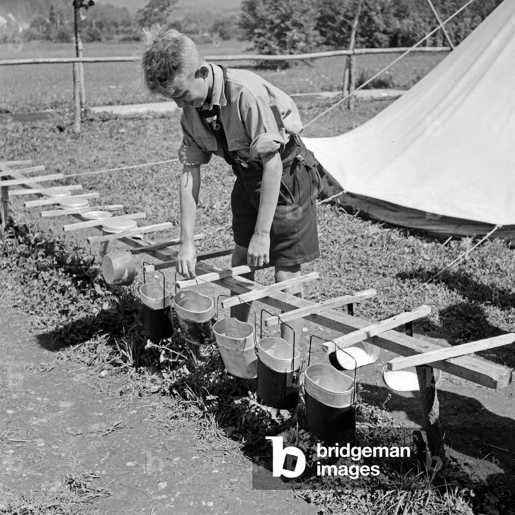 Hit Let Camp Image of A Hitler youth taking care of billy cans while his