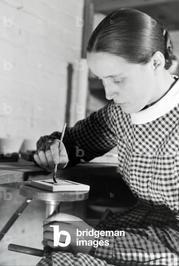A porcelain painter at work, Germany 1930s (b/w photo)