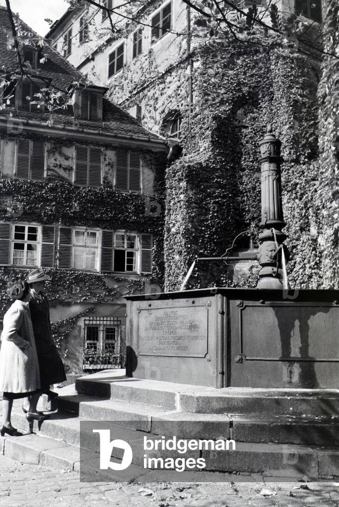 The water well with inscription on the patio of the Protestant church foundation, Tübingen, Germany 1930s (b/w photo)