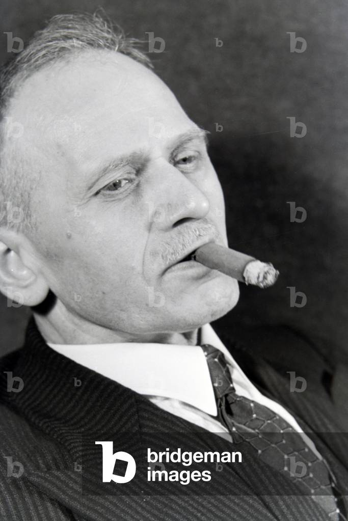 A man smoking a cigar for an advertising campaign, Germany 1930s (b/w photo)