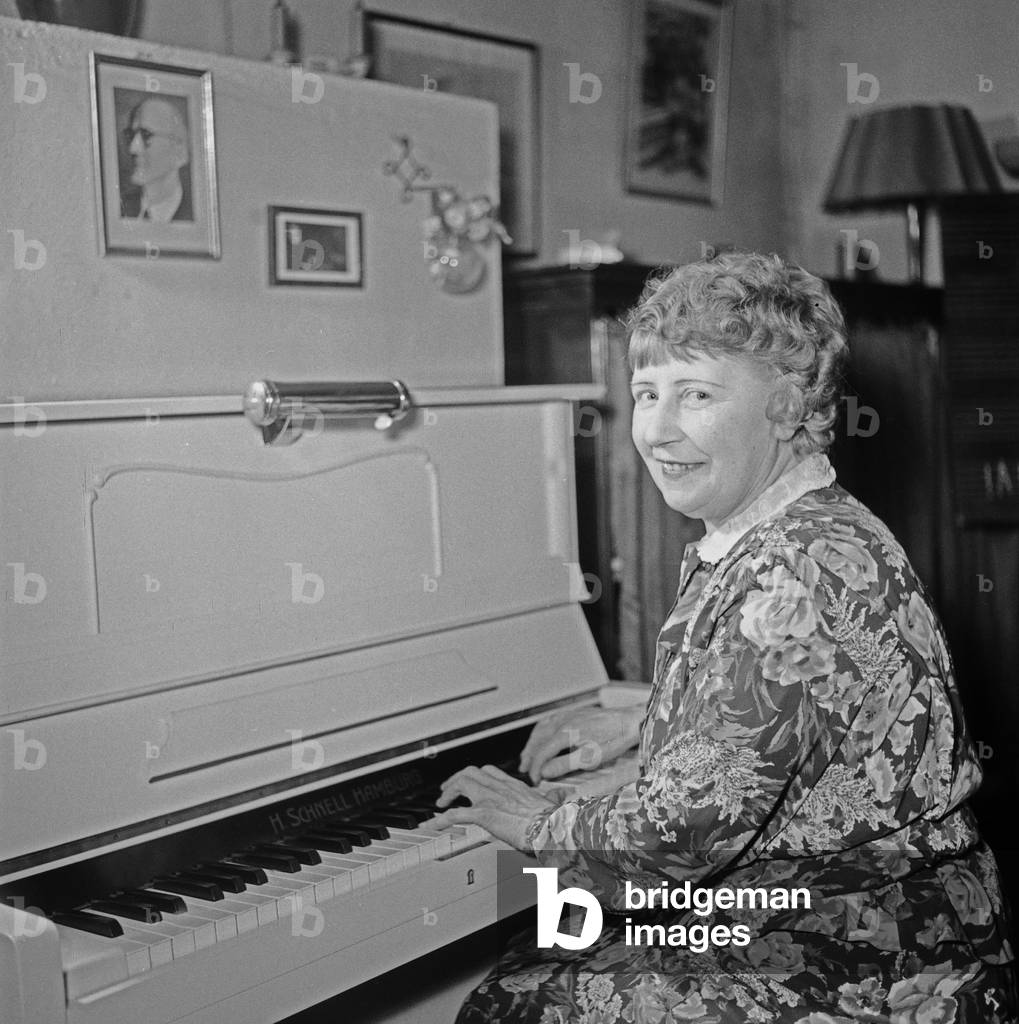 A music teacher playing on a piano