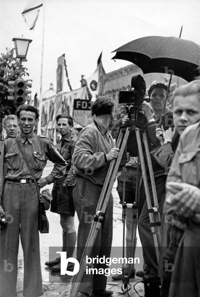 Press and film crew doing their job at a FDJ public meeting rally in East Berlin, GDR 1950s