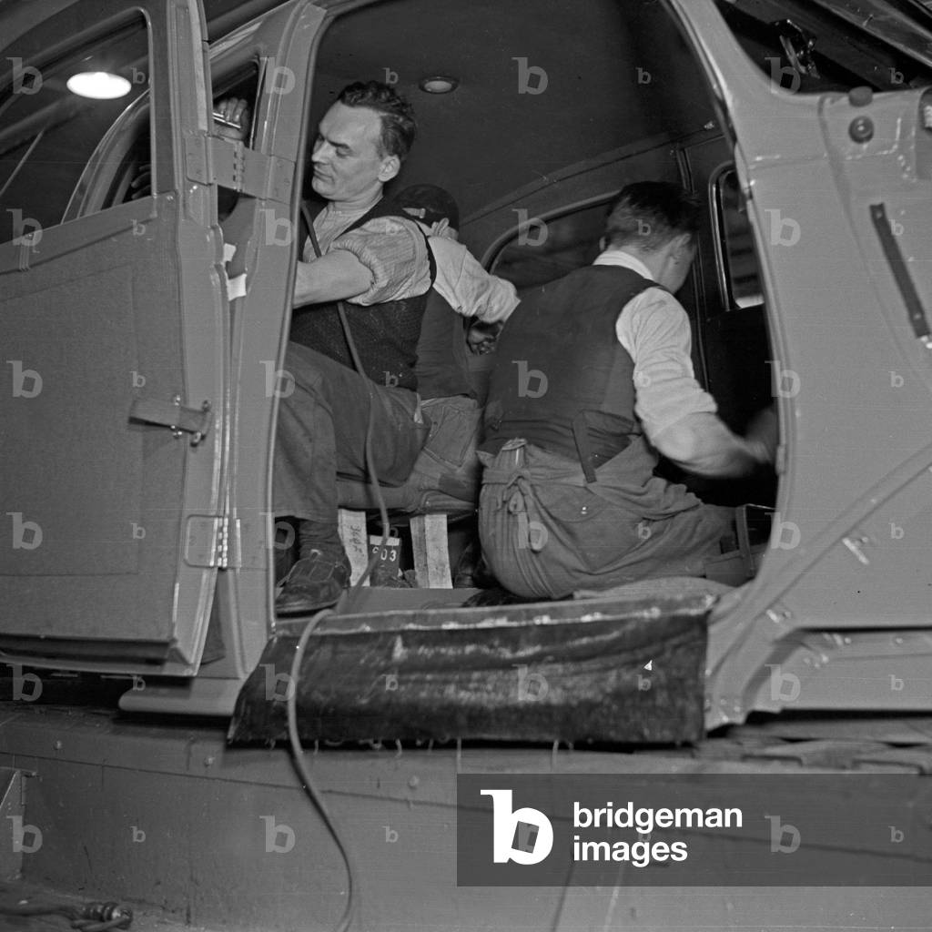 Workers at the conveyor belt of the Ford factory at Cologne, Germany 1930s (b/w photo)