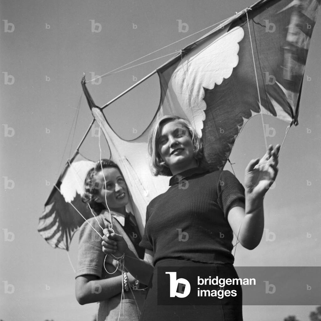 Two young women with a stunt kite, Germany 1930s (b/w photo)