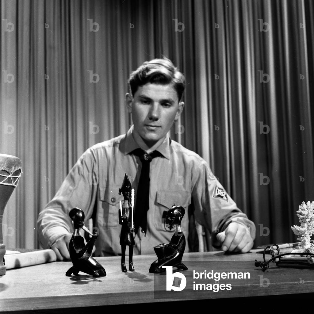 German boy scout Helfried Weyer explaining African tribal art at German TV station NDR at Hamburg, Germany 1960s