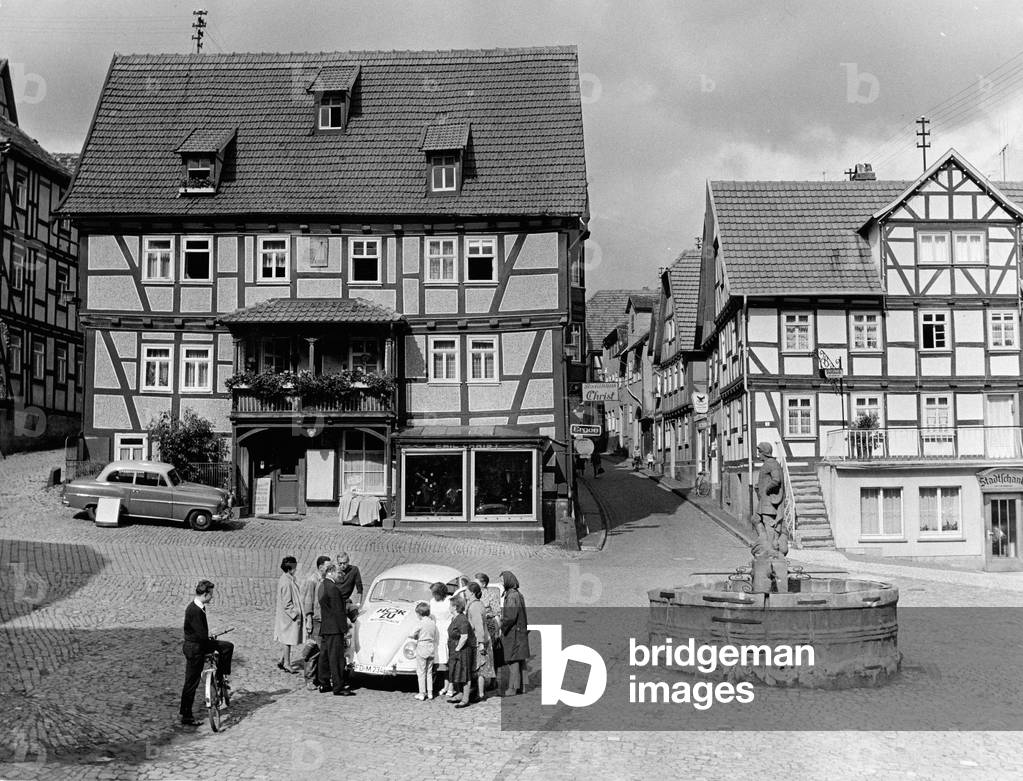 Wednesday car of German program magazine Hoerzu on a square surrounded by timbered houses at Schlitz in Eastern Hesse, Germany early 1970s
