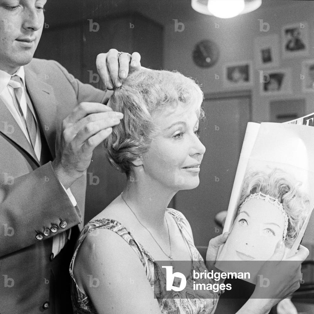 German TV presenter Angelika Feldmann checking her hairdo, Germany 1950s