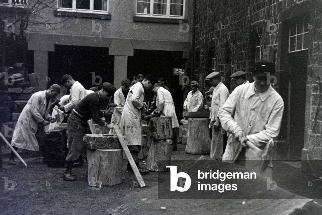 Trainees of a chiseller school at a tutorial, Germany 1937 (b/w photo)