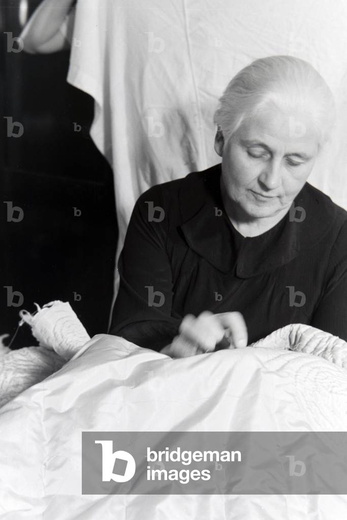 Woman embroidering textiles, Germany 1930s (b/w photo)