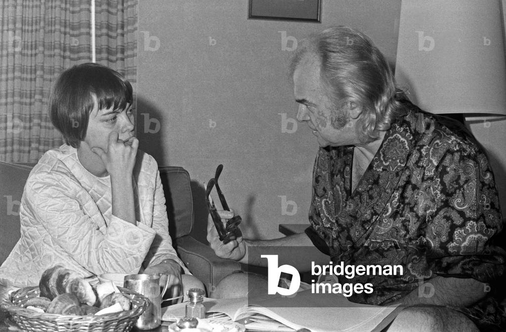 French singer Mireille Mathieu talking to her manager in a hotel at Hamburg, Germany early 1970s