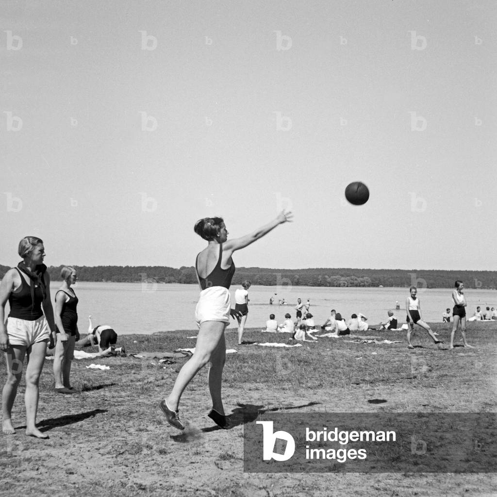 Girls playing with a ball at leisure camp of Deutsche Arbeitsfront in Altenhof, Brandenburg, 1930s (b/w photo)