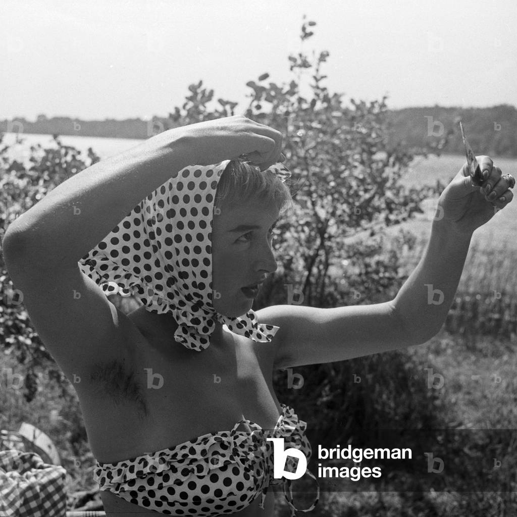 German actress, jazz and schlager singer Dany Mann on a lawn on the shore of river Elbe, Germany 1950s