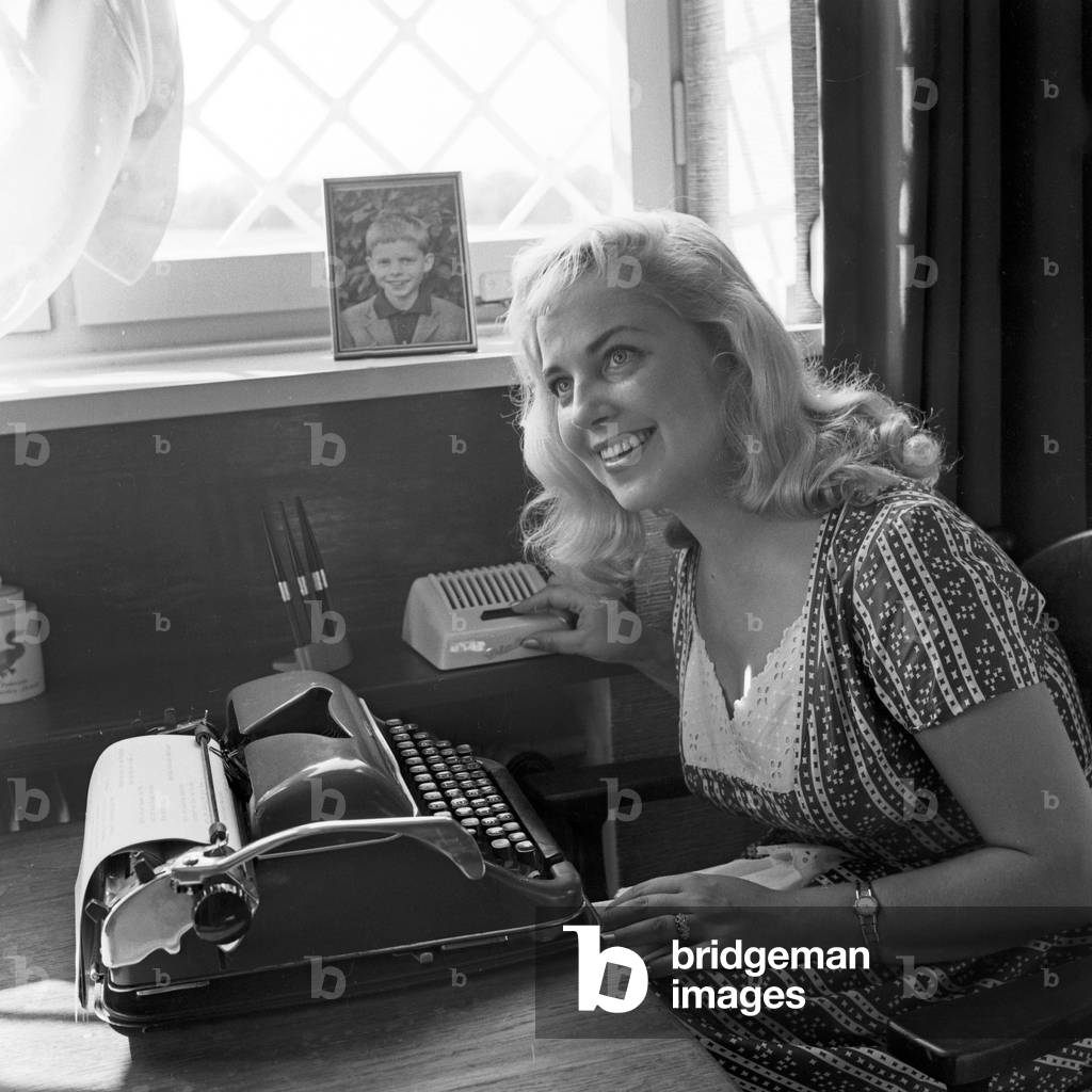 Lonny Kellner, wife of Peter Frankenfeld, as an assistant with a type writer and an interphone, Germany 1960s