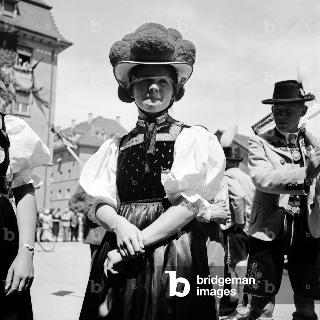 Girl wearing array of the Black Forest area at a traditional costume parade through the streets of Constance, Germany 1930s (b/w photo)