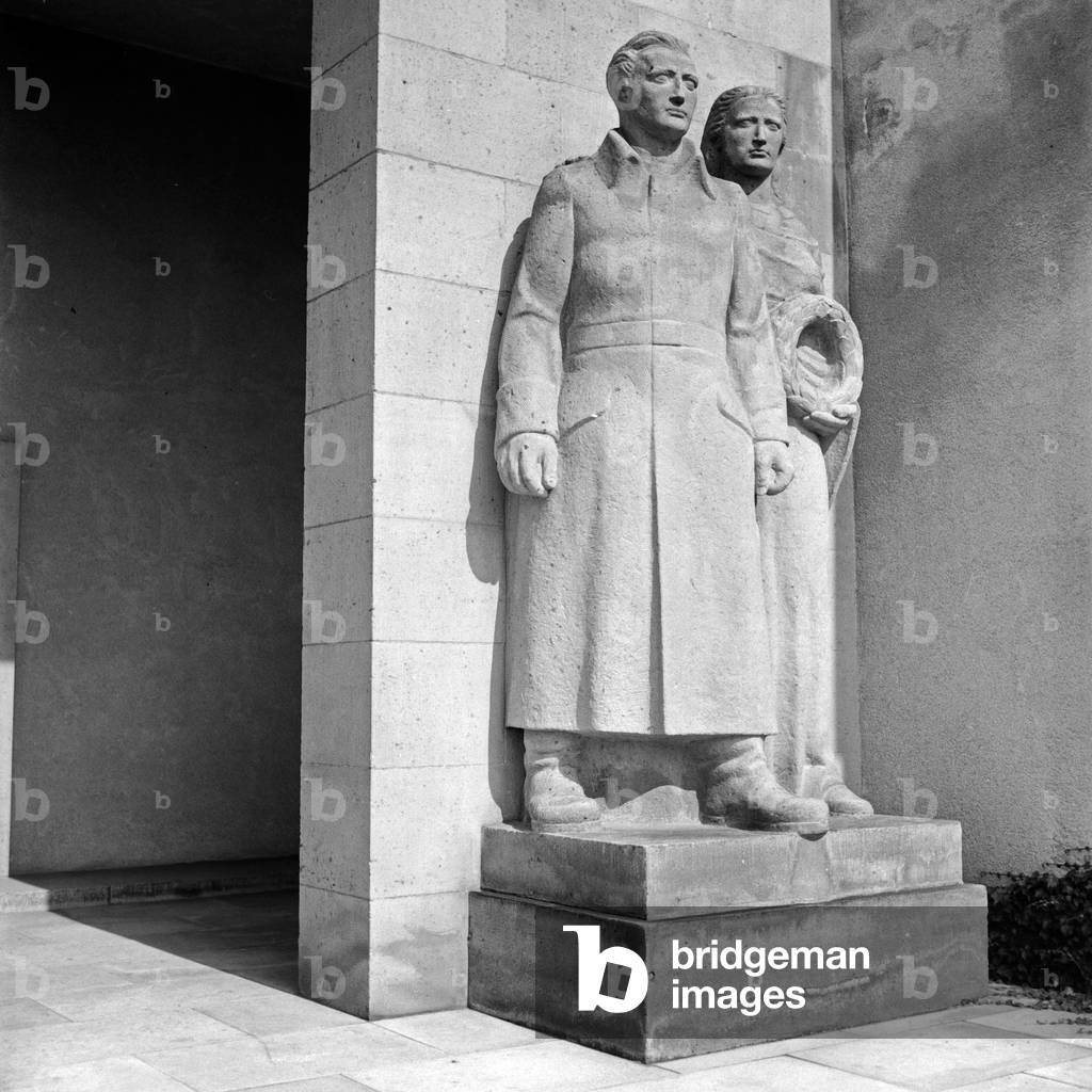 Sculpture group woman and soldier at the memorial for the fallen soldiers of WWI at Bad Nauheim, Germany 1930s (b/w photo)
