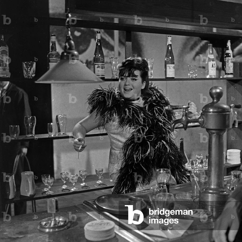 German actress, singer and later theatre manager Trude Herr playing a barmaid, 1960s