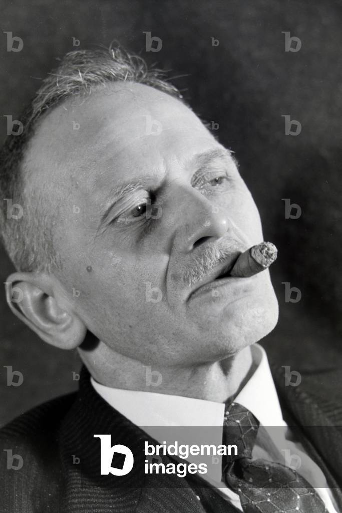 A man smoking a cigar for an advertising campaign, Germany 1930s (b/w photo)