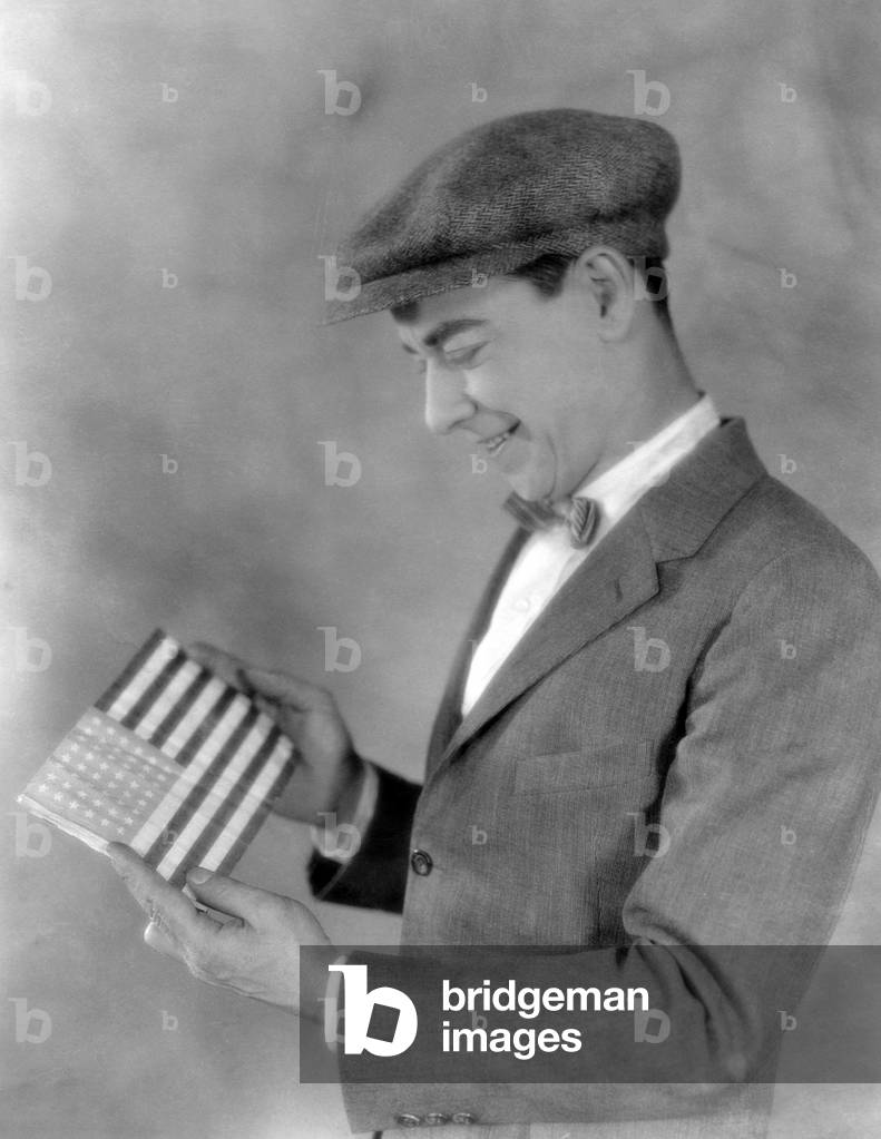 Smiling man looking at flag