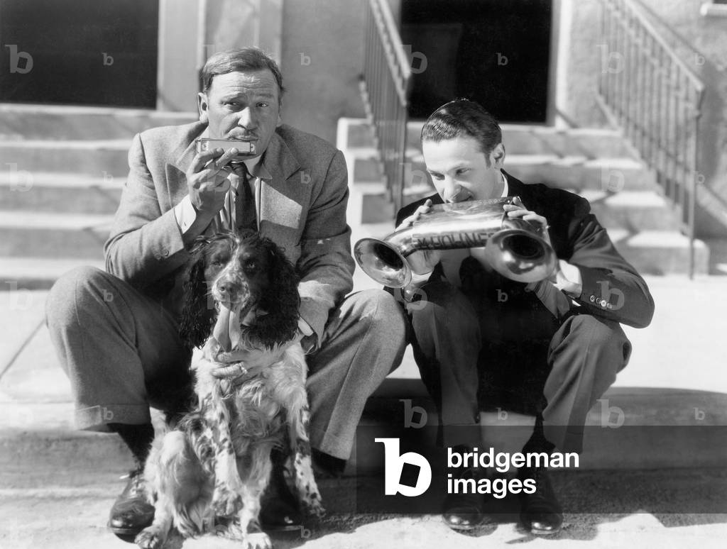 Two Men Playing Two Harmonicas with an English Setter