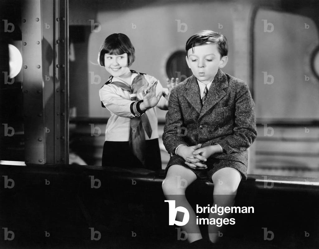 Girl Behind a Boy Pretending to Push Him Overboard