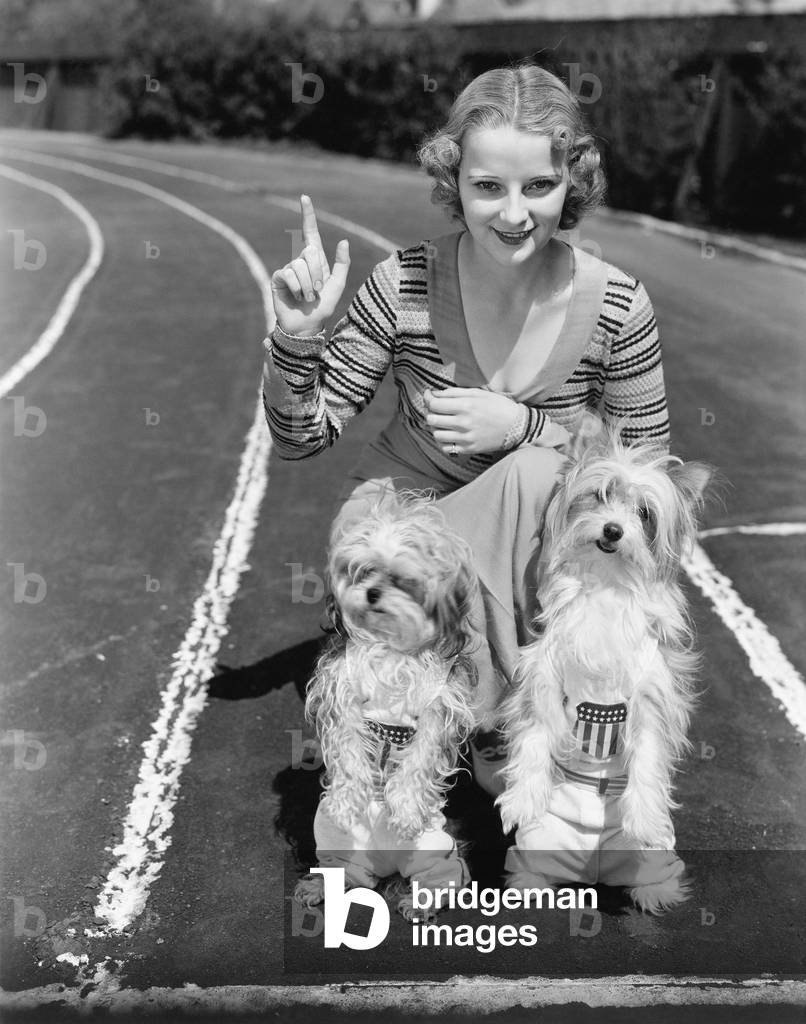 Woman with her Two Dogs on a Race Track