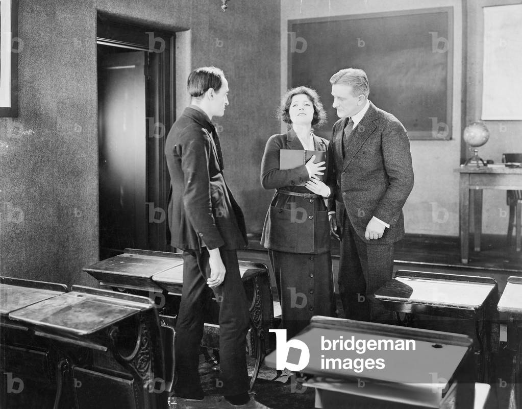 Young Woman Performing for Two Men in a Class Room