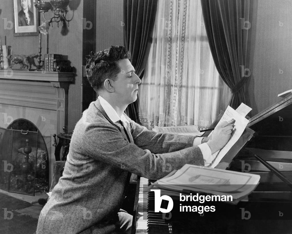 Man at Piano Writing on Sheet Music