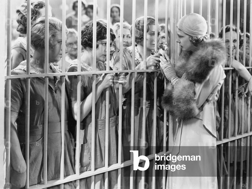 One Woman Standing in Front of a Jail Talking with a Group of Women