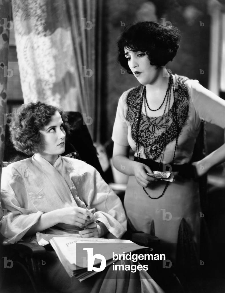 Two Young Women Discussing Financials Together